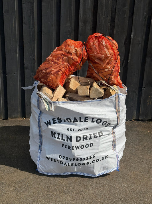 Bulk bag of kiln dried wood with two bags of kindling on top of it